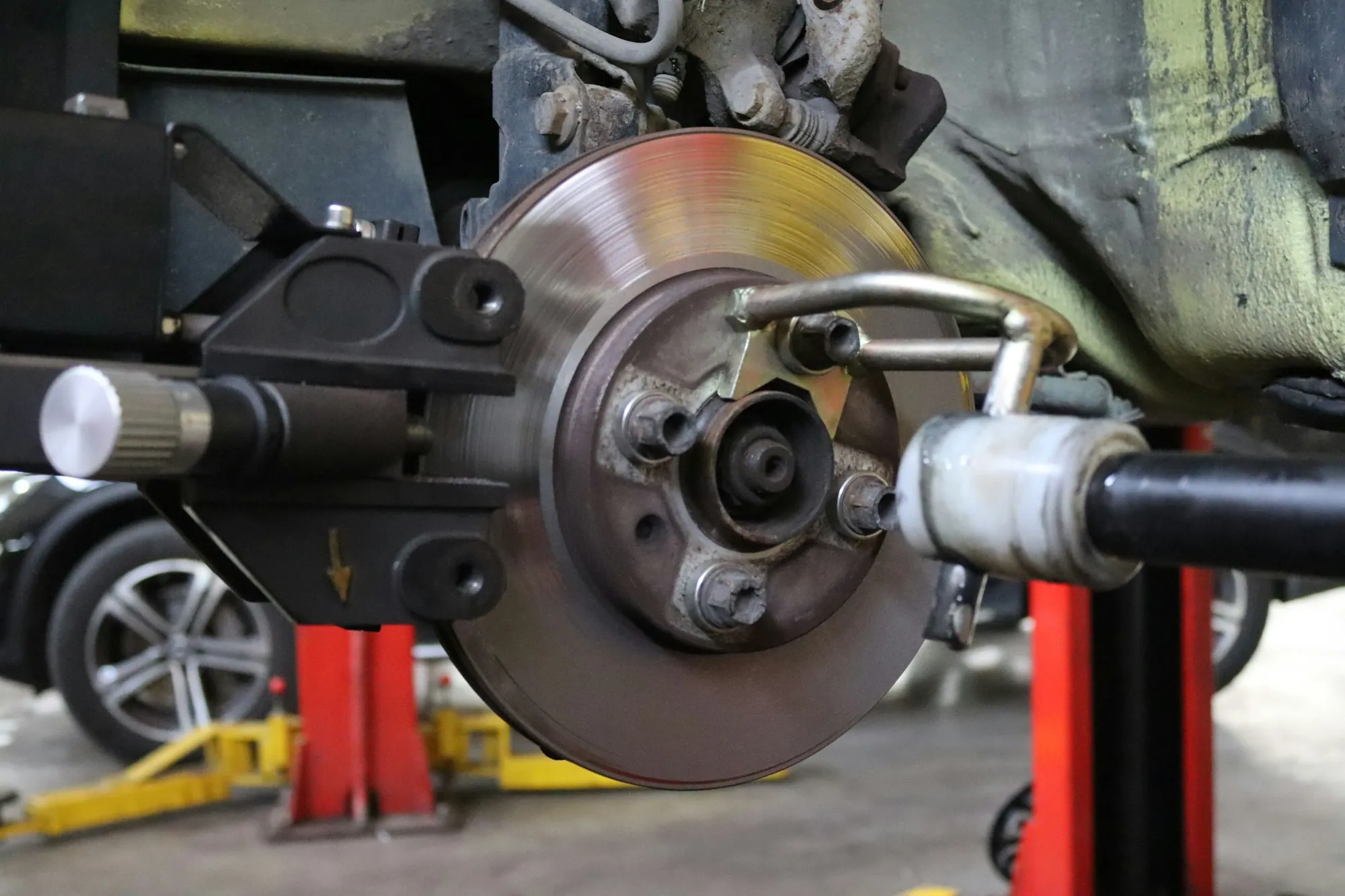 Brake rotor and caliper on a vehicle raised for service